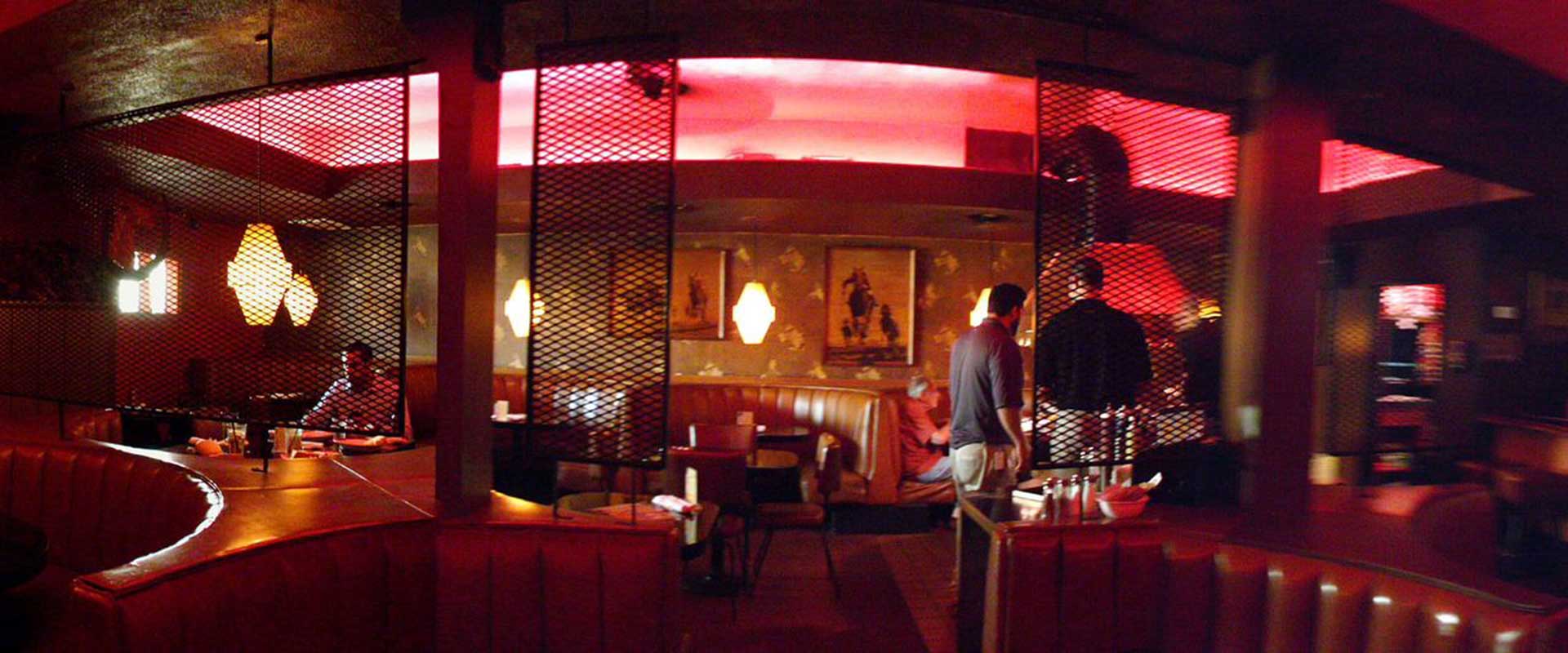 Red-lit booths and communal grilling area at Turf Supper Club in Golden Hill